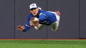 Toronto Blue Jays outfielder Daulton Varsho (5) makes a catch to out Seattle Mariners third baseman Eugenio Suárez (28) during third inning MLB American League Championship Series game 2 baseball in Toronto, Monday, Oct. 13, 2025. (Nathan Denette/CP)