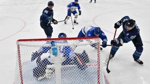 Finland's Sebastian Aho (20) scores his team's first goal during a preliminary round game of men's ice hockey between Finland and Italy at the 2026 Winter Olympics, in Milan, Italy. (Julien De Rosa/ AP)