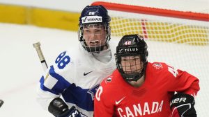 Finland's Ronja Savolainen, left, and Blayre Turnbull of Canada eye the puck during the semi final match between Canada and Finland at the Women's Ice Hockey Championships in Ceske Budejovice, Czech Republic, Saturday, April 19, 2025. (Petr David Josek/AP Photo)