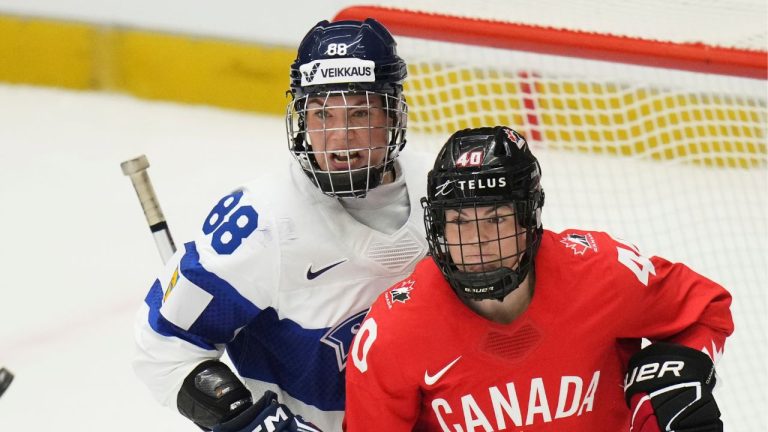 Finland's Ronja Savolainen, left, and Blayre Turnbull of Canada eye the puck during the semi final match between Canada and Finland at the Women's Ice Hockey Championships in Ceske Budejovice, Czech Republic, Saturday, April 19, 2025. (Petr David Josek/AP Photo)