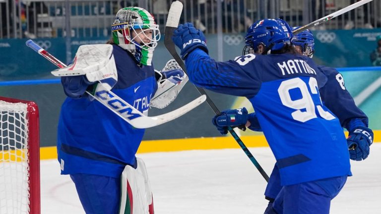 Italy's Gabriella Frances Durante, left, celebrates with teammates after a preliminary round match of women's ice hockey between Japan and Italy at the 2026 Winter Olympics, in Milan, Italy, Monday, Feb. 9, 2026. (Petr David Josek/AP)