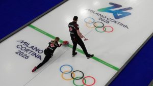 Canada's Jocelyn Peterman and Brett Gallant compete against Sweden during the mixed doubles round robin phase of the curling competition at the 2026 Winter Olympics, in Cortina d'Ampezzo, Italy, Sunday, Feb. 8, 2026. (Christophe Ena/AP Photo)