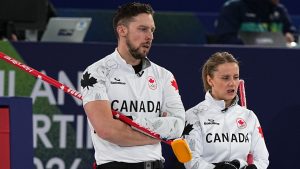 Canada's Jocelyn Peterman and Brett Gallant in action during the mixed doubles round robin phase of the curling competition against Norway, at the 2026 Winter Olympics, in Cortina d'Ampezzo, Italy, Thursday, Feb. 5, 2026. (Fatima Shbair/AP Photo)