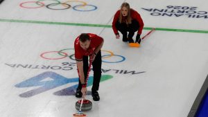 Canada's Jocelyn Peterman and Brett Gallant compete during a curling mixed doubles round robin session against Britain at the 2026 Winter Olympics, in Cortina d'Ampezzo, Italy, Saturday, Feb. 7, 2026. (Christophe Ena/AP Photo)