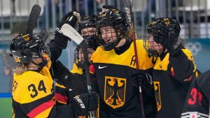 Germany's Laura Kluge, centre, celebrates with teammates after scoring her sides fifth goal during a preliminary round match of women's ice hockey between Germany and Japan at the 2026 Winter Olympics, in Milan, Italy, Saturday, Feb. 7, 2026. (Petr David Josek/AP Photo)
