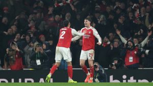 Arsenal's Kai Havertz, right, celebrates with Arsenal's William Saliba after scoring the opening goal during the English League Cup semifinal second leg soccer match between Arsenal and Chelsea in London, Tuesday, Feb. 3, 2026. (Ian Walton/AP)