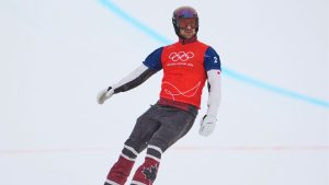 Canada's Eliot Grondin (2) reacts after crossing the finish line during the men's snowboard cross finals at the 2026 Winter Olympics, in Livigno, Italy, Thursday, Feb. 12, 2026. (Lindsey Wasson/AP Photo)