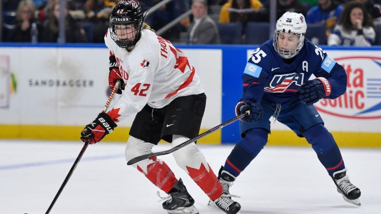 Canada defender Claire Thompson (42) shields the puck from United States forward Alex Carpenter during the second period of a Rivalry Series women's hockey game, Saturday, Nov. 8, 2025, in Buffalo, N.Y. (Adrian Kraus/AP Photo)