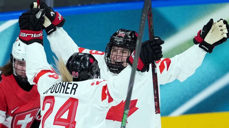 Canada’s Marie-Philip Poulin (29) and Natalie Spooner (24) celebrate a goal against Switzerland during the second period of a preliminary round women's hockey game at the Milan Cortina Winter Olympics, in Milan, on Saturday, Feb. 7, 2026. (Darryl Dyck/THE CANADIAN PRESS)