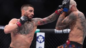 Ilia Topuria, left, fights Charles Oliveira in a lightweight title fight at UFC 317 in Las Vegas. (John Locher/AP)