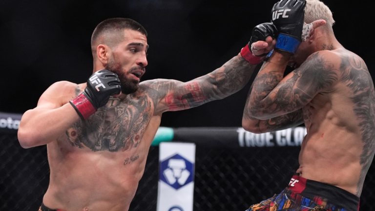 Ilia Topuria, left, fights Charles Oliveira in a lightweight title fight at UFC 317 in Las Vegas. (John Locher/AP)