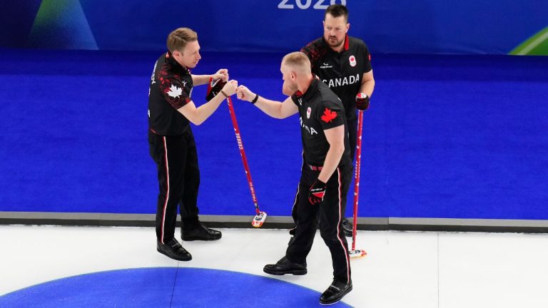 Canada's Brad Jacobs, Marc Kennedy and Ben Hebert celebrate after beating the United States during a men's curling round robin match at the 2026 Winter Olympics, in Cortina d'Ampezzo, Italy, Friday, Feb. 13, 2026. (David J. Phillip/AP Photo)