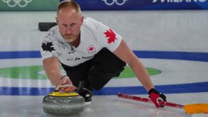 Canada's Brad Jacobs in action during the men's curling round robin session against China, at the 2026 Winter Olympics, in Cortina d'Ampezzo, Italy, Sunday, Feb. 15, 2026. (Misper Apawu/AP Photo)