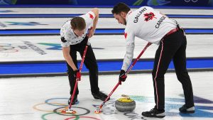 Canada's Marc Kennedy and Brett Gallant in action during the men's curling round robin session against Norway at the 2026 Winter Olympics, in Cortina d'Ampezzo, Italy, Thursday, Feb. 19, 2026. (Fatima Shbair/AP Photo)