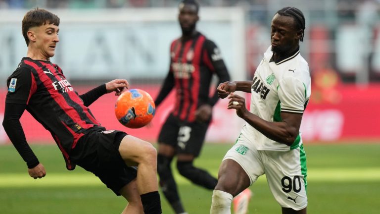 AC Milan's Alexis Saelemaekers, left, duels for the ball with Sassuolo's Ismael Kone during the Serie A soccer match between AC Milan and Sassuolo, in Milan, Italy, Sunday, Dec. 14, 2025. (Luca Bruno/AP)