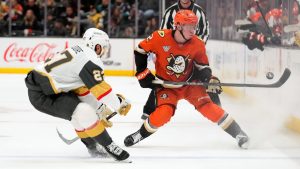 Anaheim Ducks defenceman Jackson LaCombe, right, tries to control the puck while under pressure from Vegas Golden Knights defenceman Shea Theodore during the third period of an NHL hockey game Saturday, Nov. 22, 2025, in Anaheim, Calif. (Mark J. Terrill/AP)