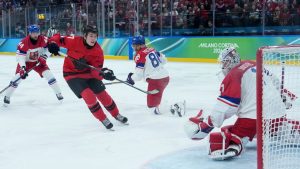 Canada's Macklin Celebrini (17) scores goal against Czechia goalie Lukas Dostal (1) during the first period of a quarterfinal men's hockey game at the 2026 Winter Olympics, in Milan, on Wednesday, Feb. 18, 2026. (Darryl Dyck/CP)