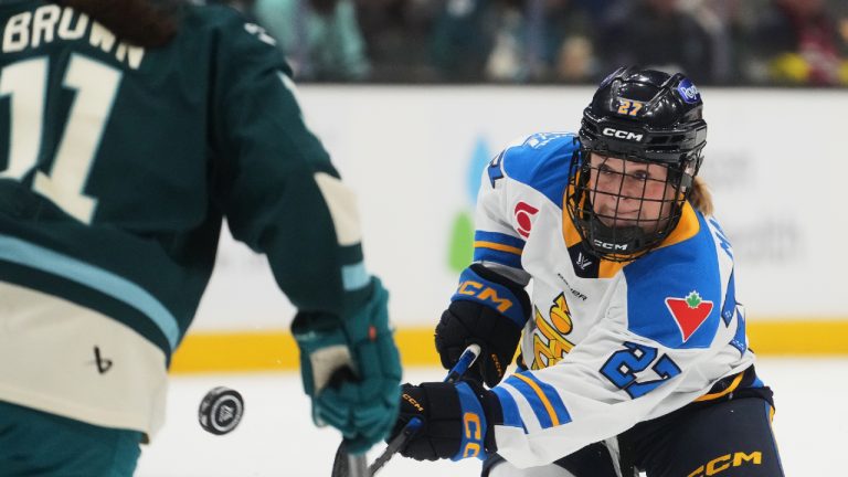 Toronto Sceptres forward Emma Maltais, right, chips the puck past Seattle Torrent defender Emily Brown, left, during the third period of a PWHL hockey game, Tuesday, Jan. 20, 2026, in Seattle. (Lindsey Wasson/AP)