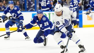 Toronto Maple Leafs right wing William Nylander (88) cuts around Tampa Bay Lightning center Zemgus Girgensons (28) and defenseman J.J. Moser (90) during the first period of an NHL hockey game Wednesday, Feb. 25, 2026, in Tampa, Fla. (Chris O'Meara/AP)