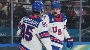 United States' Auston Matthews, right, celebrates after scoring his side's fifth goal during a preliminary round game of men's ice hockey between the United States and Germany at the 2026 Winter Olympics, in Milan, Italy, Sunday, Feb. 15, 2026. (Carolyn Kaster/AP Photo)