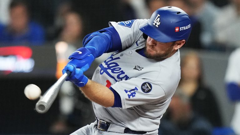 Los Angeles Dodgers' Max Muncy (13) hits a solo home run against the Toronto Blue Jays during eighth inning Game 7 World Series playoff MLB baseball action in Toronto on Saturday, Nov. 1, 2025. (Nathan Denette/CP)