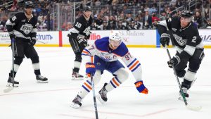 Edmonton Oilers center Connor McDavid, third from left, moves the puck past Los Angeles Kings right wing Quinton Byfield, right wing Corey Perry, and defenseman Brian Dumoulin, from left, during the third period of an NHL hockey game Thursday, Feb. 26, 2026 in Los Angeles. (Ryan Sun/AP)