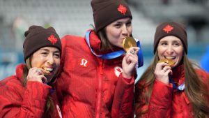 Canada's Ivanie Blondin, Isabelle Weidemann, centre, and Valerie Maltais, right, celebrate winning gold medals on the podium after the final of the women's team pursuit speedskating race at the 2026 Winter Olympics, in Milan, Italy, Tuesday, Feb. 17, 2026. (Nathan Denette/THE CANADIAN PRESS)