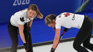 Canada's Sarah Wilkes and Emma Miskew in action during the women's curling round robin session against Japan at the 2026 Winter Olympics, in Cortina d'Ampezzo, Italy, Monday, Feb. 16, 2026. (Fatima Shbair/AP Photo)
