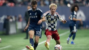 Vancouver Whitecaps' Thomas Muller and Real Salt Lake's Luca Moisa vie for the ball during the first half of an MLS match in Vancouver, on Saturday, February 21, 2026. (THE CANADIAN PRESS/Ethan Cairns)