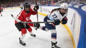 United States' Abbey Murphy (37) is checked by Canada's Kristin O'Neill (43) during second period Rivalry Series action in Edmonton on Saturday, December 13, 2025. (Jason Franson/THE CANADIAN PRESS)
