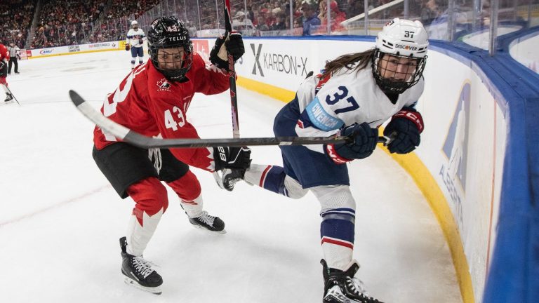 United States' Abbey Murphy (37) is checked by Canada's Kristin O'Neill (43) during second period Rivalry Series action in Edmonton on Saturday, December 13, 2025. (Jason Franson/THE CANADIAN PRESS)