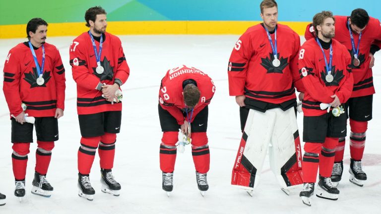 Canada's Nathan MacKinnon (29) hangs his head while getting his silver medal after losing to the United States in overtime during the men's gold medal hockey game at the 2026 Winter Olympics, in Milan, on Sunday, Feb. 22, 2026. (Darryl Dyck/CP)