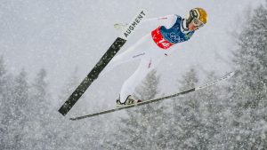 Stefan Rettenegger, of Austria, soars through the air during the Nordic combined team sprint at the 2026 Winter Olympics, in Predazzo, Italy, Thursday, Feb. 19, 2026. (Evgeniy Maloletka/AP Photo)