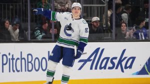 Vancouver Canucks left wing Liam Ohgren (92) celebrates after making the game-winning goal in a shootout against Seattle Kraken goaltender Joey Daccord in an NHL hockey game Monday, Dec. 29, 2025, in Seattle. (Lindsey Wasson/AP)