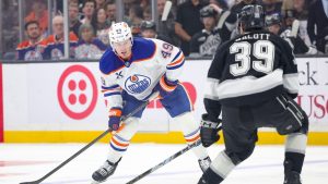 Edmonton Oilers defenceman Ty Emberson, left, moves the puck against Los Angeles Kings left wing Jeff Malott during the first period of an NHL hockey game Thursday, Feb. 26, 2026 in Los Angeles. (Ryan Sun/AP)