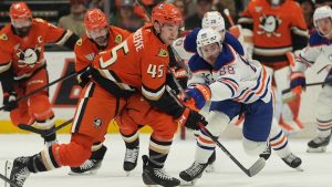 Anaheim Ducks right wing Beckett Sennecke (45) battles Edmonton Oilers left wing Andrew Mangiapane (88) for the puck during the first period of an NHL hockey game Wednesday, Feb. 25, 2026, in Anaheim, Calif. (Gregory Bull/AP)