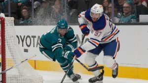 Edmonton Oilers center Connor McDavid (97) skates with the puck against San Jose Sharks defenseman John Klingberg during the second period of an NHL hockey game in San Jose, Calif., Saturday, Feb. 28, 2026. (Jeff Chiu/AP)