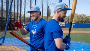 Toronto Blue Jays' Kazuma Okamoto (left) acknowledges cheers as he walks past Nathan Lukes after a home run in batting practice at Spring Training in Dunedin, Fla., on Monday, Feb. 16, 2026. THE CANADIAN PRESS/Frank Gunn