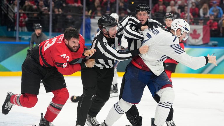 France's Pierre Crinon (7) and Canada's Tom Wilson (43) fight in the third period during a preliminary round game of men's ice hockey between Canada and France at the 2026 Winter Olympics, in Milan, Italy, Sunday, Feb. 15, 2026. (Hassan Ammar/AP)