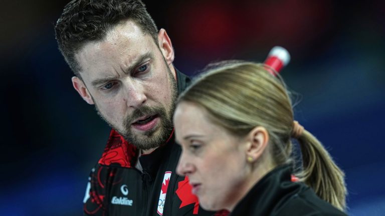 Canada's Brett Gallant and Jocelyn Peterman speak during the mixed doubles round robin phase of the curling competition against Sweden, at the 2026 Winter Olympics, in Cortina d'Ampezzo, Italy, Sunday, Feb. 8, 2026. (Fatima Shbair/AP)