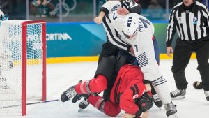France's Pierre Crinon (7) and Canada's Tom Wilson (43) fight in the third period during a preliminary round game of men's ice hockey between Canada and France at the 2026 Winter Olympics, in Milan, Italy, Sunday, Feb. 15, 2026. (Hassan Ammar/AP)