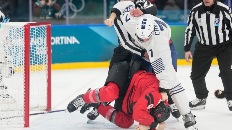 France's Pierre Crinon (7) and Canada's Tom Wilson (43) fight in the third period during a preliminary round game of men's ice hockey between Canada and France at the 2026 Winter Olympics, in Milan, Italy, Sunday, Feb. 15, 2026. (Hassan Ammar/AP)