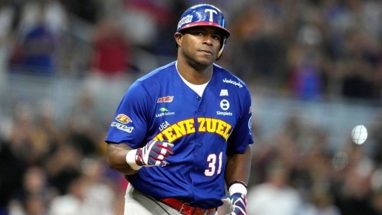 Venezuela's Yasiel Puig heads to first after drawing a bases loaded walk to score Ehire Adrianza during the third inning of a Caribbean Series baseball game against Curacao, Saturday, Feb. 3, 2024, in Miami. (Lynne Sladky/AP)