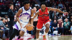 Utah Jazz's Isaiah Collier (8) and Toronto Raptors' Immanuel Quickley (5) battle for the ball during first half NBA basketball action in Toronto, on Sunday, Feb. 1, 2026. (Sammy Kogan/CP)