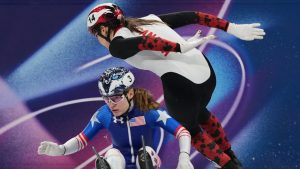 Corinne Stoddard of the United States crashes as Courtney Sarault of Canada avoids her while competing in the team mixed relay short track speed skating at the 2026 Winter Olympics, in Milan, Italy, Tuesday, Feb. 10, 2026. (Stephanie Scarbrough/AP Photo)