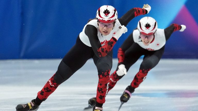 Canada's Courtney Sarault (14) and Florence Brunelle (8) compete in the women's 500 metre short track speedskating quarterfinals at the 2026 Winter Olympics, in Milan, on Thursday, Feb. 12, 2026. (Darryl Dyck/THE CANADIAN PRESS)