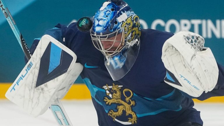 Finland's goalkeeper Juuse Saros makes a save during a preliminary round match of men's ice hockey between Finland and Sweden at the 2026 Winter Olympics, in Milan, Italy, Friday, Feb. 13, 2026. (Hassan Ammar/AP Photo)