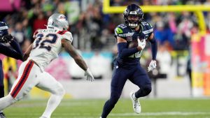 Seattle Seahawks safety Julian Love, right, returns an interception against New England Patriots running back TreVeyon Henderson (32) during the second half of the NFL Super Bowl 60 football game, Sunday, Feb. 8, 2026, in Santa Clara, Calif. (Steve Luciano/AP)