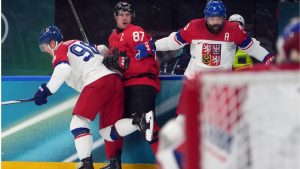 Canada's Sidney Crosby (87) is hit against the boards by Czechia's Martin Necas (98) and Radko Gudas (3) during the second period of a men's ice hockey quarterfinal game at the 2026 Winter Olympics, in Milan, Italy, Wednesday, Feb. 18, 2026. Crosby went to the dressing room after the play. (Carolyn Kaster/AP)