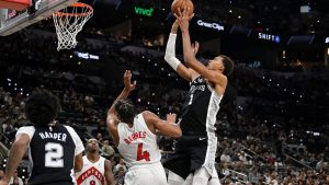 San Antonio Spurs centre Victor Wembanyama (1) shoots against Toronto Raptors guard Scottie Barnes (4) during the second half of an NBA basketball game, Monday, Oct. 27, 2025, in San Antonio. (Darren Abate/AP)